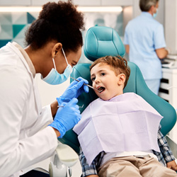 Dentist examining child's teeth
