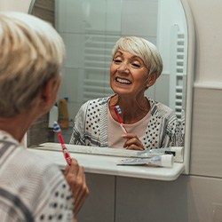 Patient in Lisle cleaning their dentures