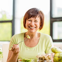 Patient in Lisle eating with dentures