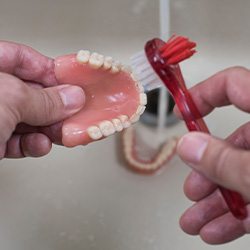 Patient in Lisle cleaning their dentures