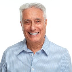 Senior man in button-up shirt smiling