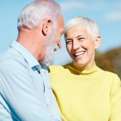 Senior couple walking outside and smiling