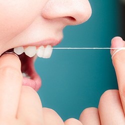 Woman flossing her teeth